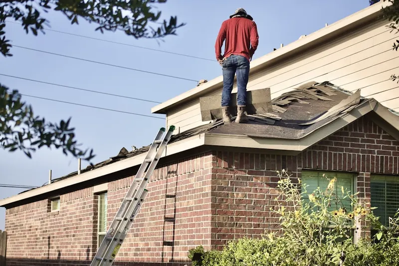 Professional roofer working on a residential roof in Bahama
